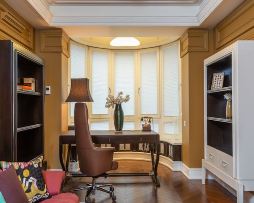 Comfortable home office with soft natural lighting and window blinds to prevent glare